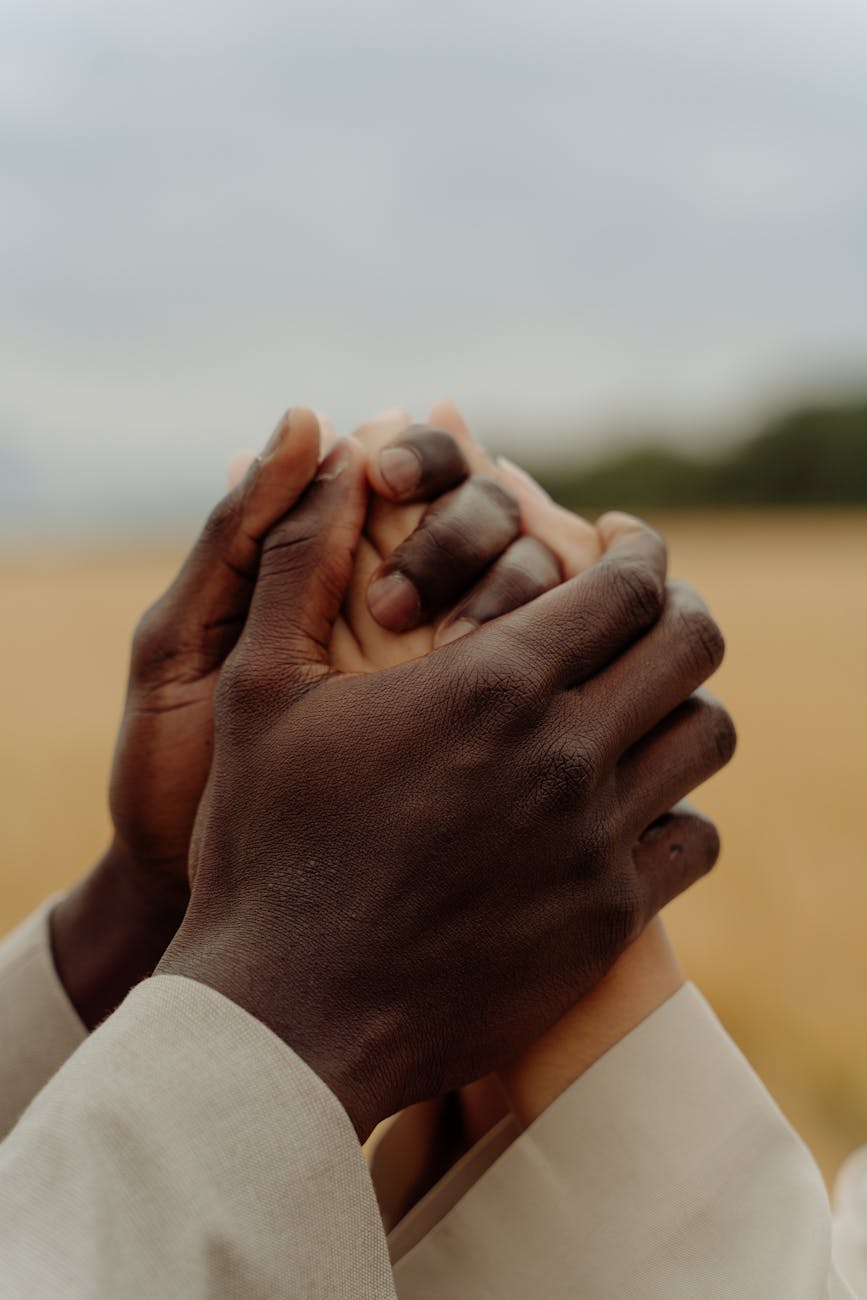 close up shot of two people holding hands together
