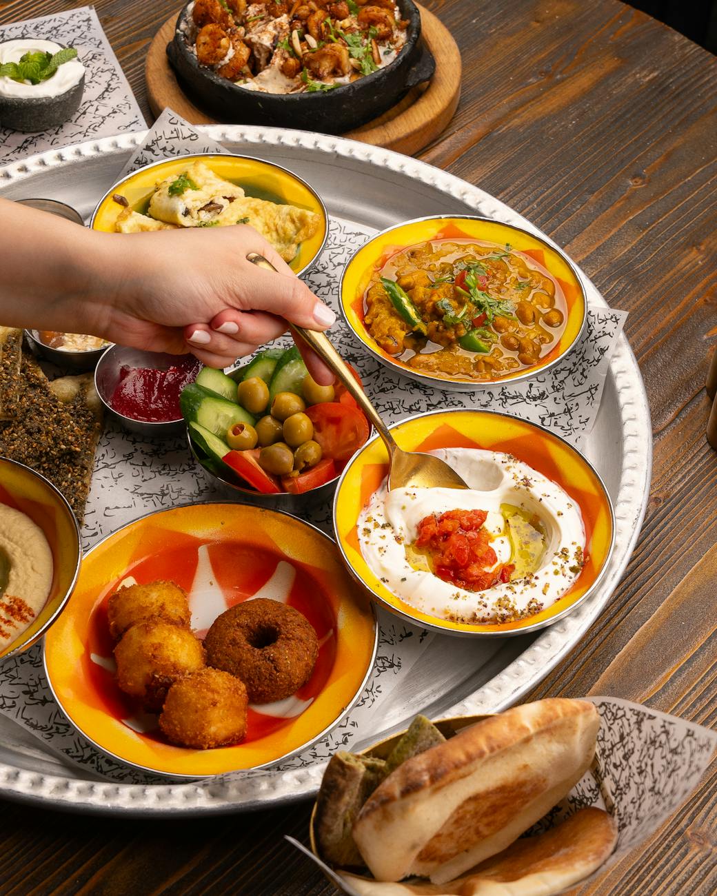 a person is holding a plate of food with different dishes